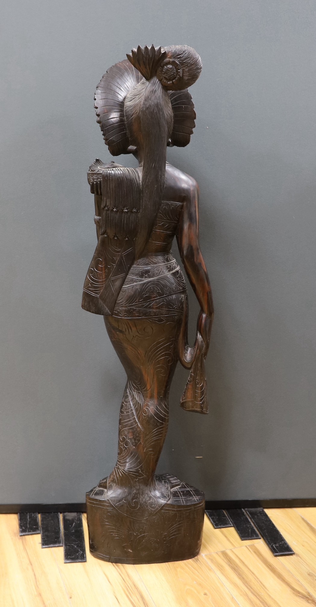 An unusually large and well-carved Balinese ebony figure of a standing young girl, early/mid 20th century. From a Bournemouth estate, 105cm high